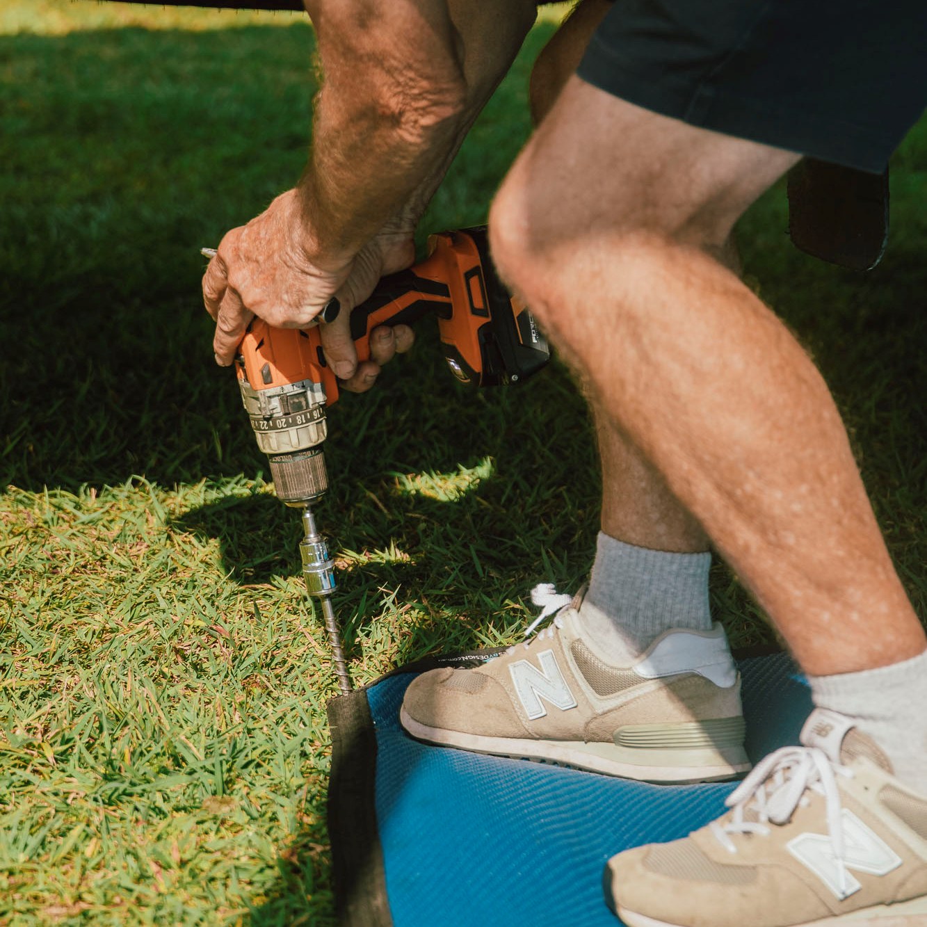 Ground Puppies Screw in Peg being screwed into a caravan mat